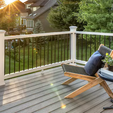 Backyard deck overlooking grass with patio chair