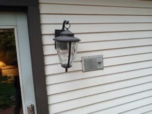 Before view of lighting fixtures on siding