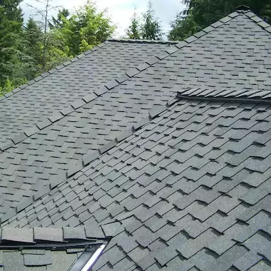 Asphalt designer shingles on a hipped rooftop